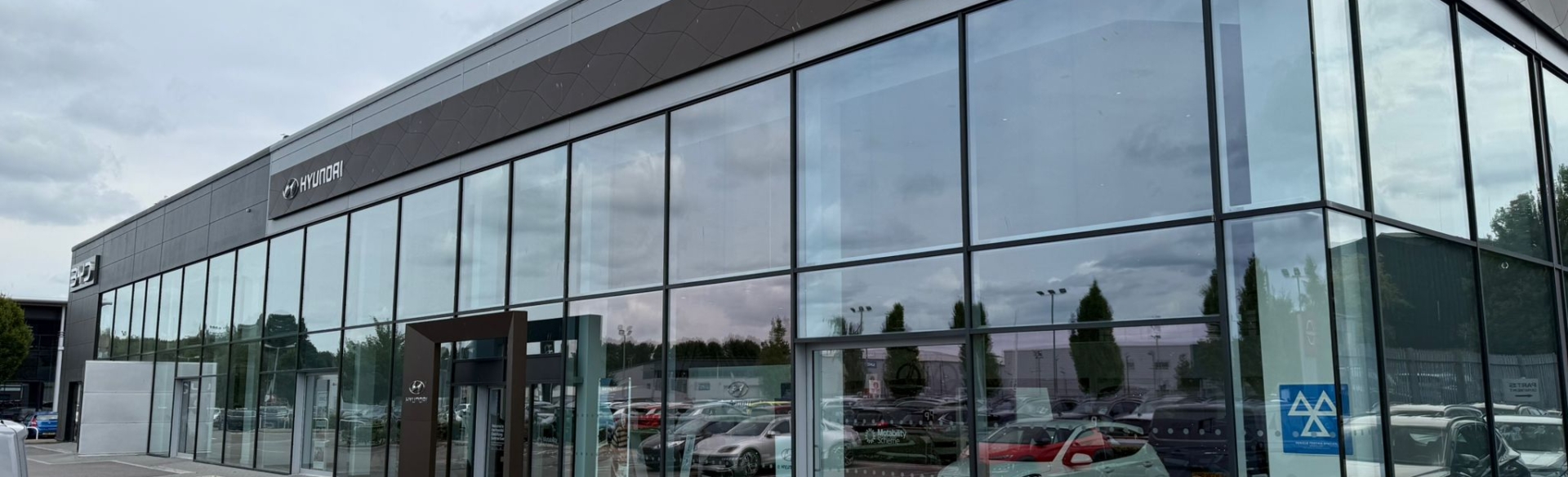 Commercial car showroom with extensive glazing fitted with solar control window film, helping reduce heat and glare while maintaining clear visibility for retail display windows