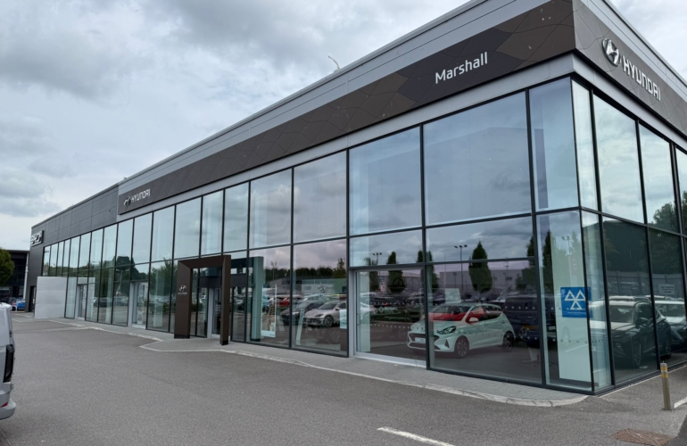 Commercial car showroom with extensive glazing fitted with solar control window film, helping reduce heat and glare while maintaining clear visibility for retail display windows