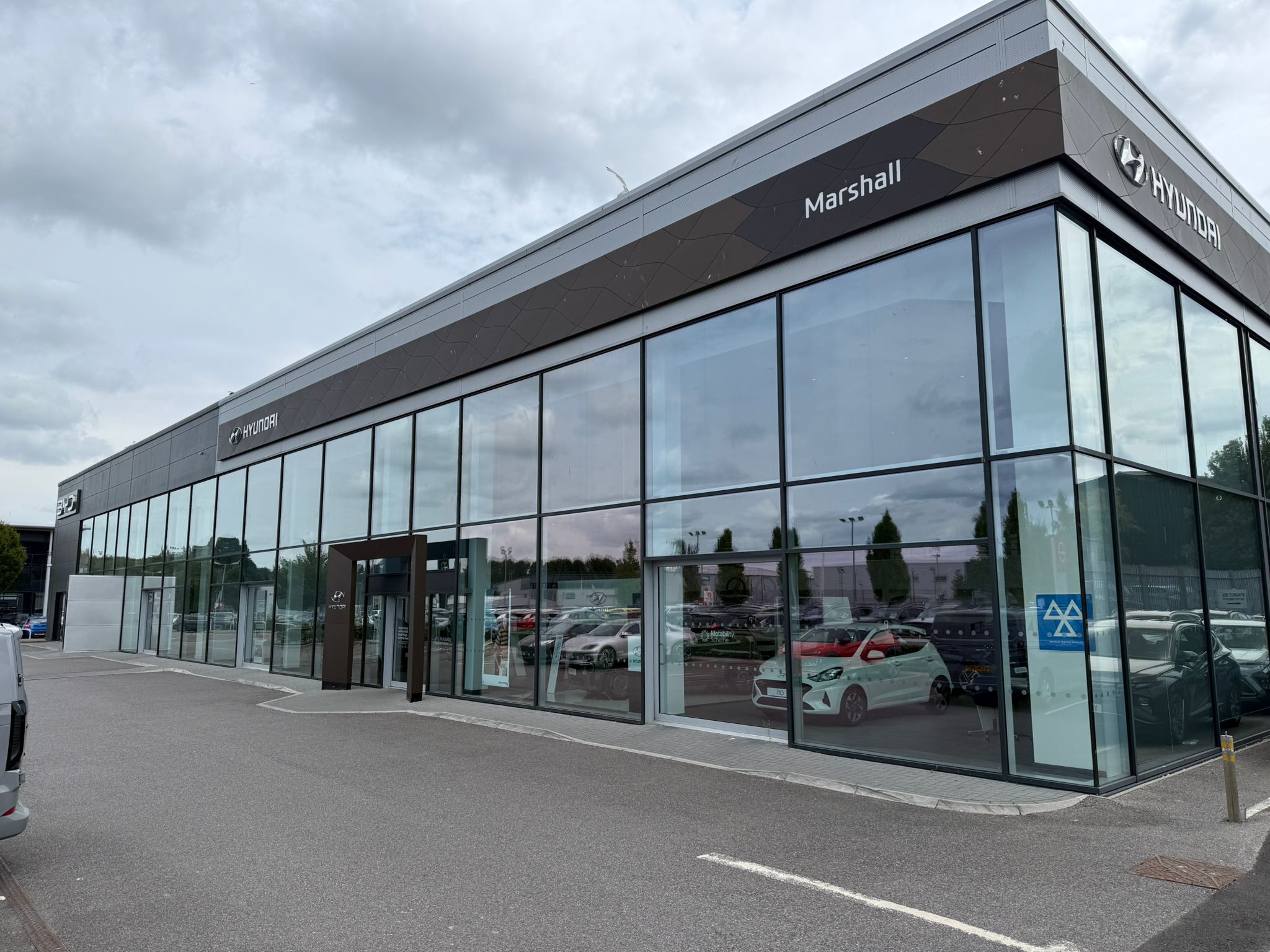 Commercial car showroom with extensive glazing fitted with solar control window film, helping reduce heat and glare while maintaining clear visibility for retail display windows