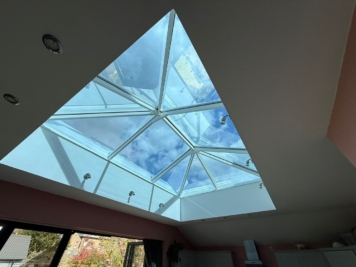 Interior roof lantern fitted with solar control window film, reducing glare and heat gain while maintaining natural daylight in modern kitchen extension.