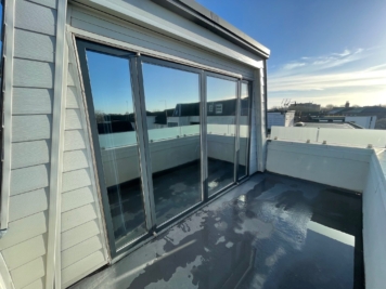 Balcony sliding doors fitted with solar control window film, enhancing privacy, glare reduction and temperature control for residential apartment.