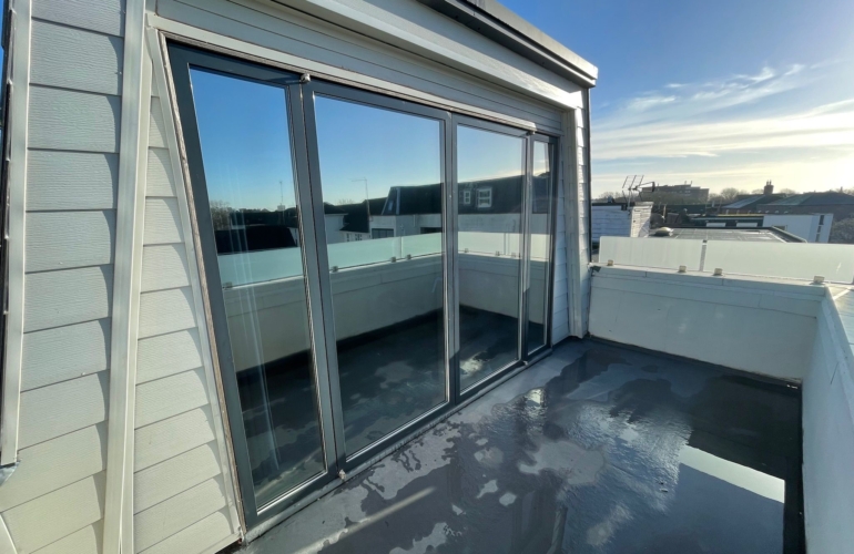 Balcony sliding doors fitted with solar control window film, enhancing privacy, glare reduction and temperature control for residential apartment.