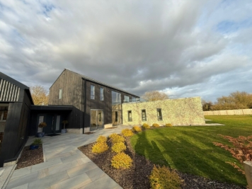Modern residential property with large glazed windows treated with solar control window film, enhancing energy efficiency, glare reduction and comfort throughout the home