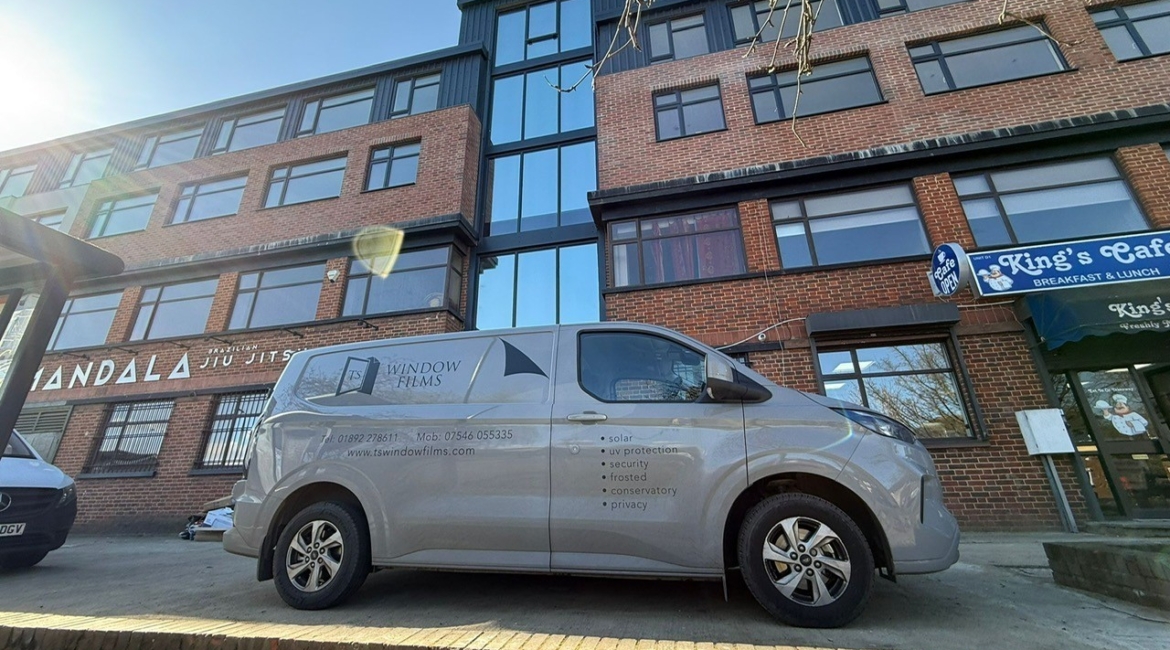TS Window Films branded van parked outside commercial premises, providing professional solar control, security and privacy window film installation services in Sussex