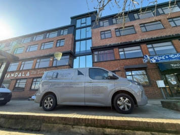 TS Window Films branded van parked outside commercial premises, providing professional solar control, security and privacy window film installation services in Sussex