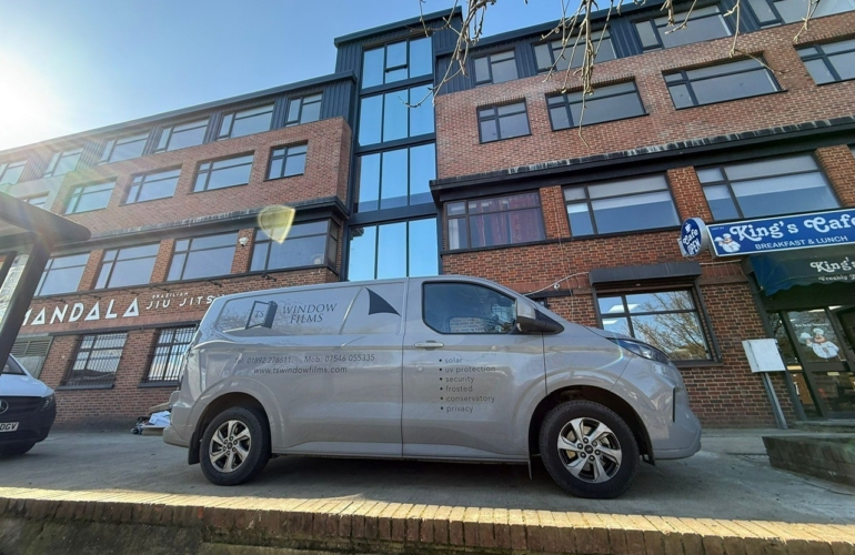 TS Window Films branded van parked outside commercial premises, providing professional solar control, security and privacy window film installation services in Sussex